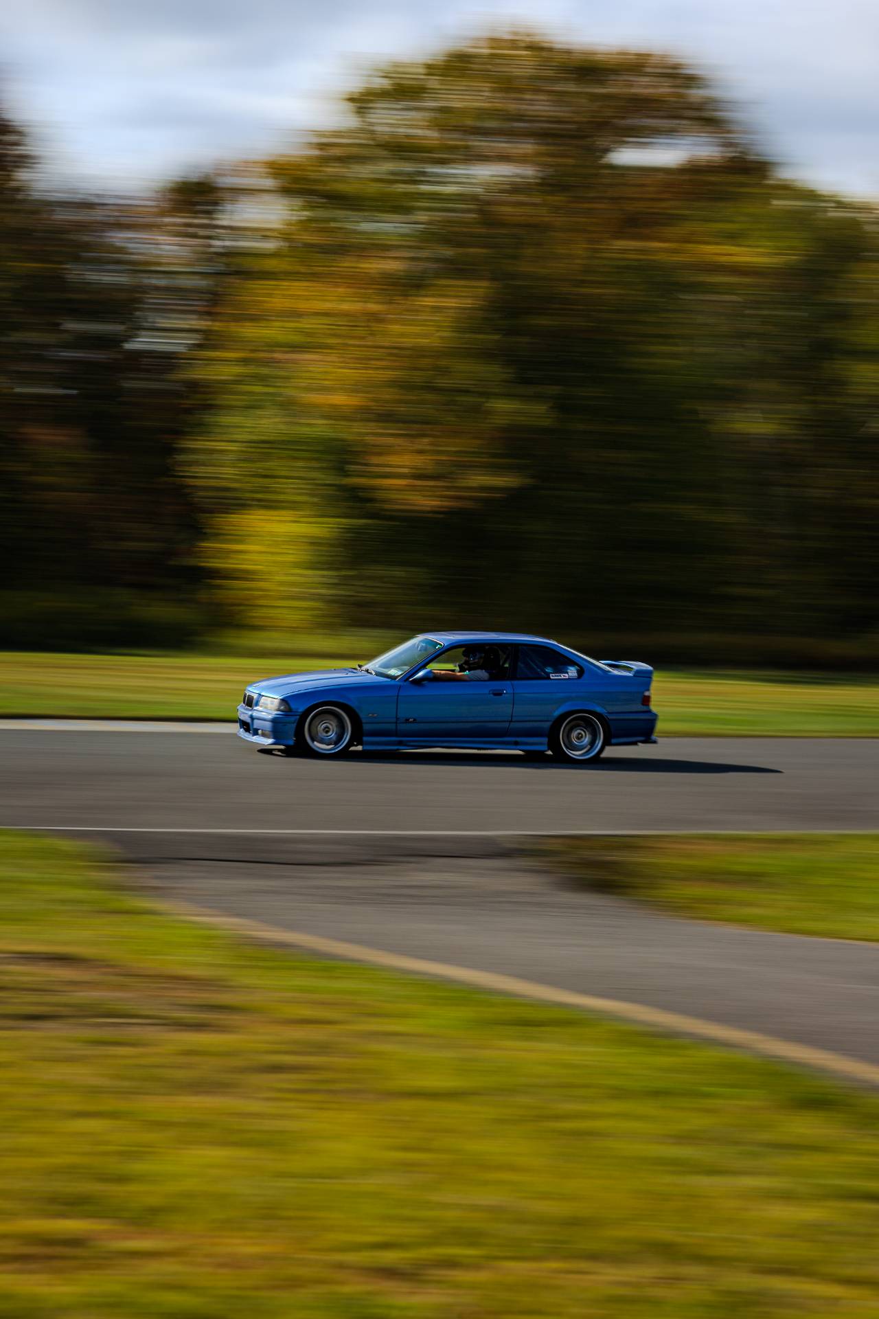 Blue E36 M3 carving through the corner